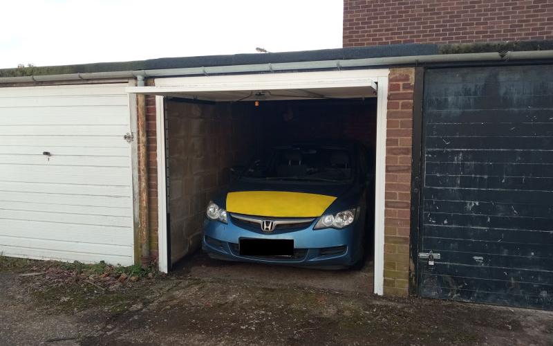 Garage with Honda Civic parked inside